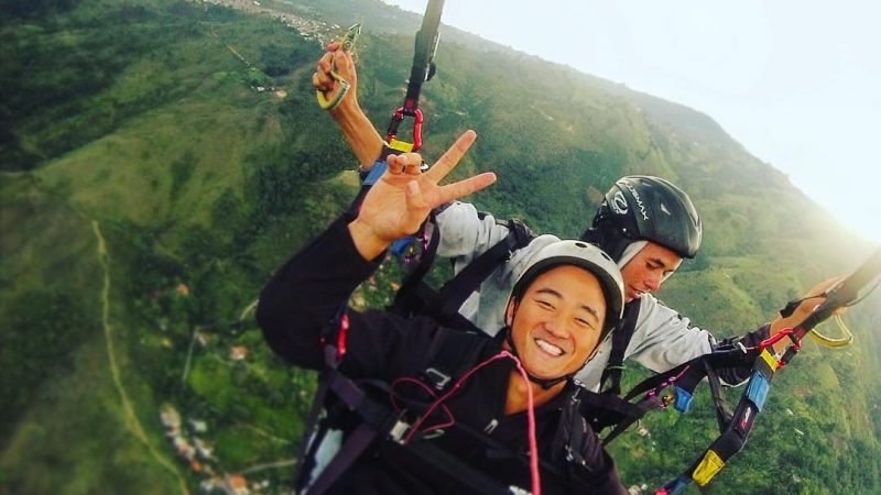 Digital nomad Ben Hebert soaring over Colombia in a parachute