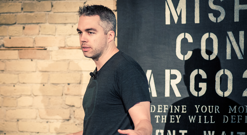 Digital nomad Clay Hebert speaking at MisfitCon