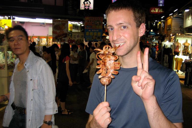 Digital Nomad Eytan Levy noshes on squid in Taiwan