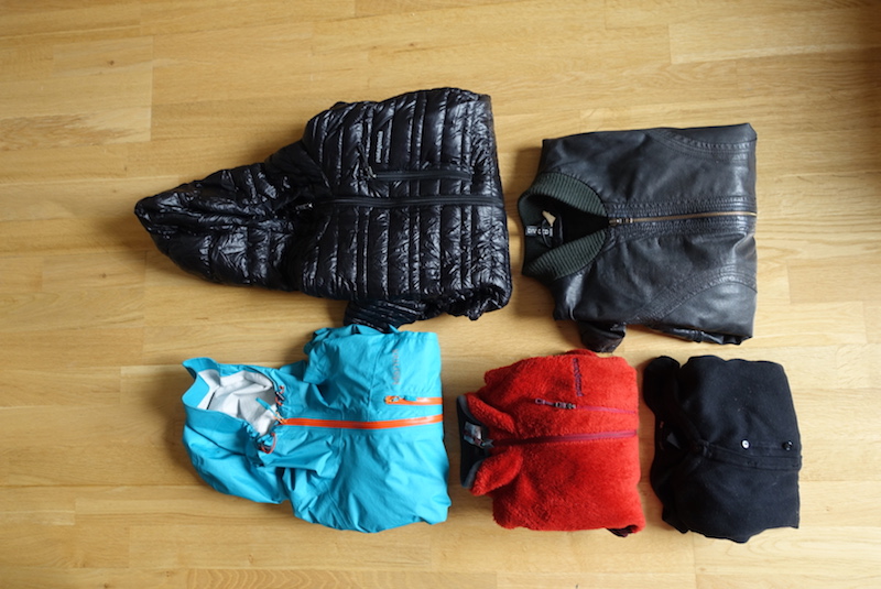 Travel gear and outerwear packed into the main compartment of the Minaal Carry-on