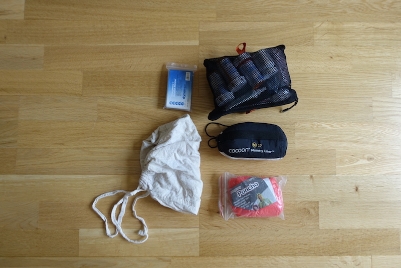 Travel gear packed into lower zip pocket in main compartment of Minaal Carry-on