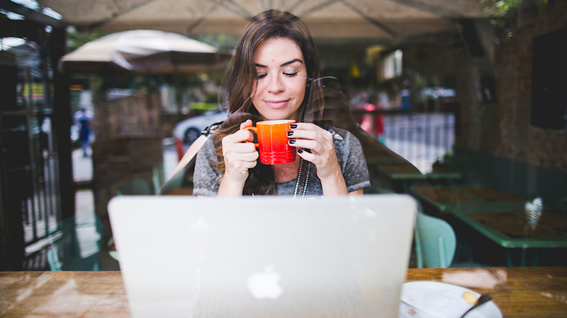 How fast do digital nomads travel - Fernanda_Neute sips coffee at outdoor cafe